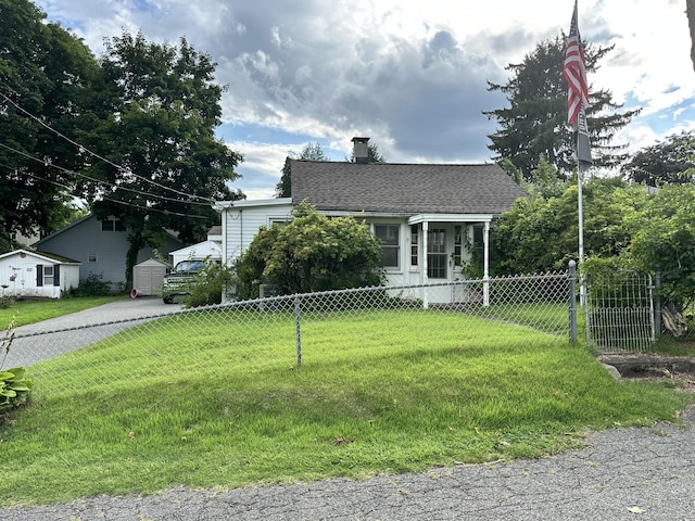 bungalow-style home with a front lawn