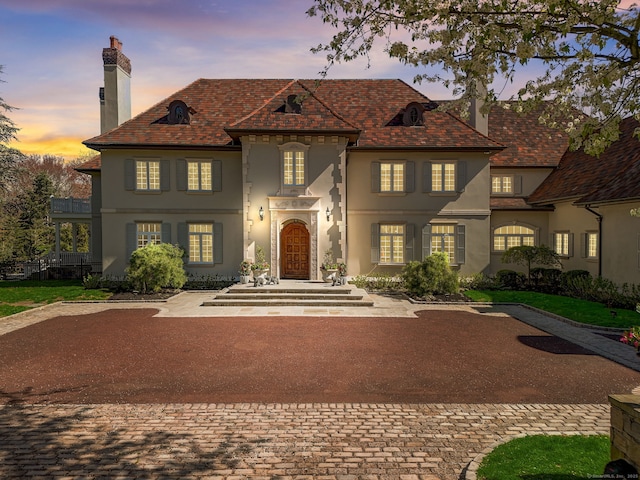 4 Cowdray Park Dr, Greenwich, CT 06831 - french provincial home featuring stucco siding and a chimney