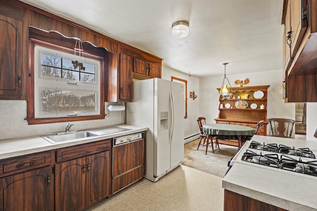 kitchen with decorative light fixtures, sink, a baseboard heating unit, dark brown cabinetry, and white appliances