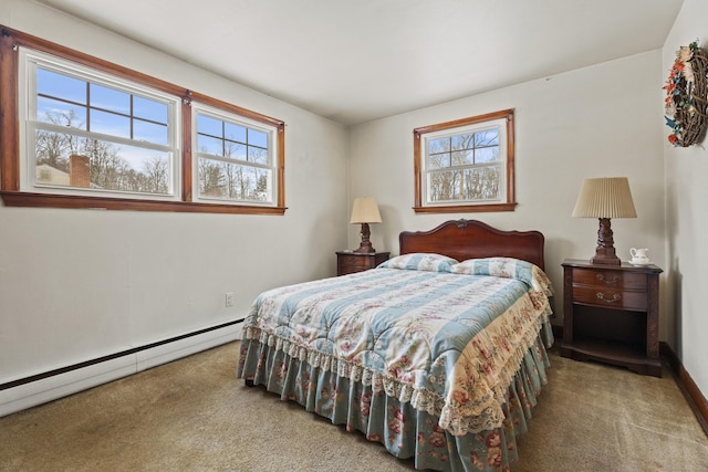 bedroom with carpet flooring and a baseboard heating unit