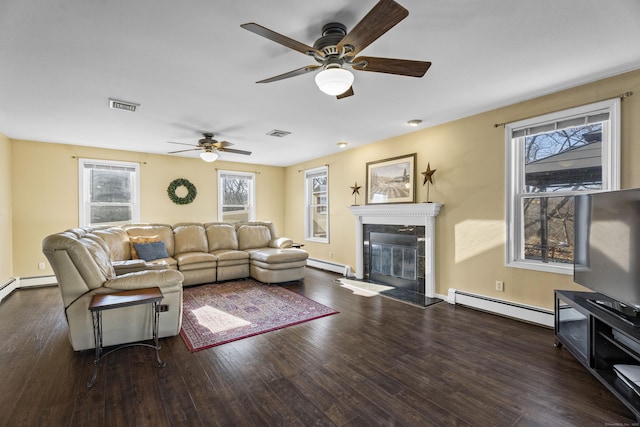 living room featuring ceiling fan, baseboard heating, and dark hardwood / wood-style flooring