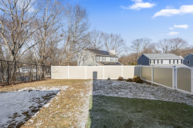 view of yard layered in snow