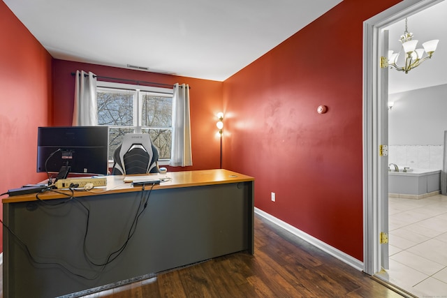 office area with wood-type flooring and a notable chandelier