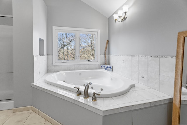 bathroom with vaulted ceiling, tile patterned flooring, and a bathtub