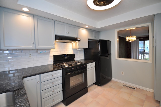 kitchen with backsplash, black appliances, decorative light fixtures, dark stone counters, and a chandelier