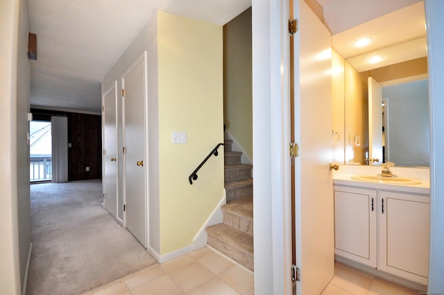 interior space with sink and light colored carpet