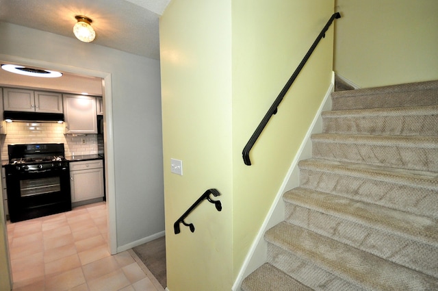 staircase with tile patterned floors