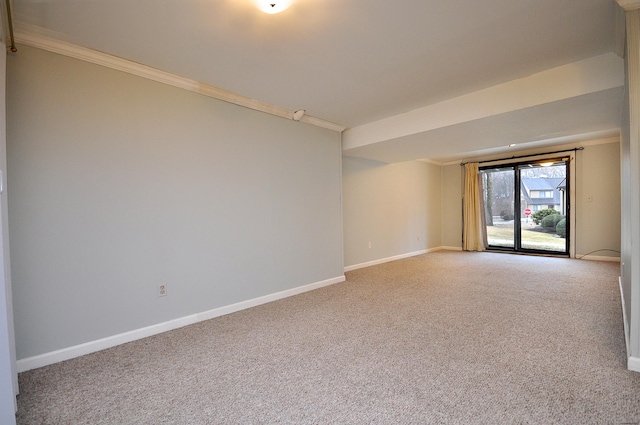 carpeted empty room featuring crown molding