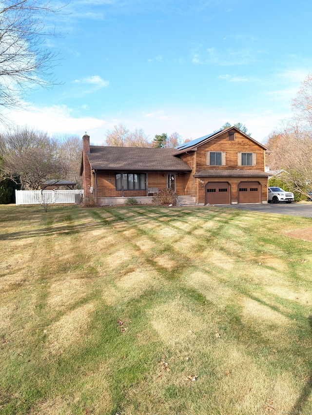 view of front of property with a front lawn and a garage