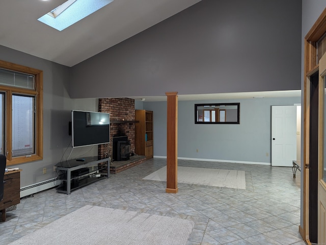 tiled living room featuring a baseboard heating unit and vaulted ceiling with skylight