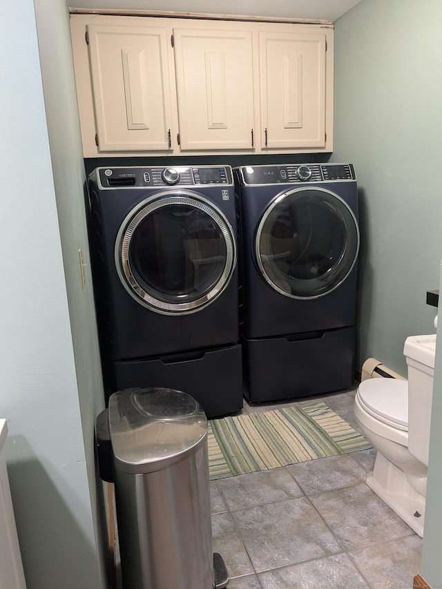 washroom with cabinets and independent washer and dryer