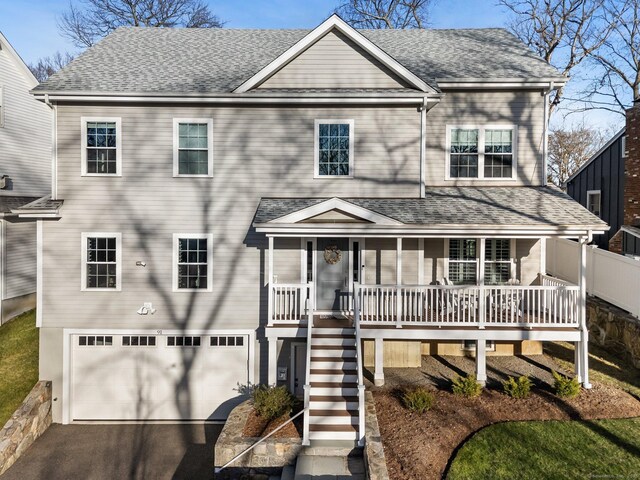 view of front of property with a garage and covered porch