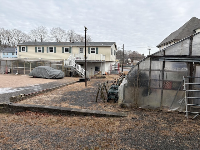 rear view of house with an outdoor structure