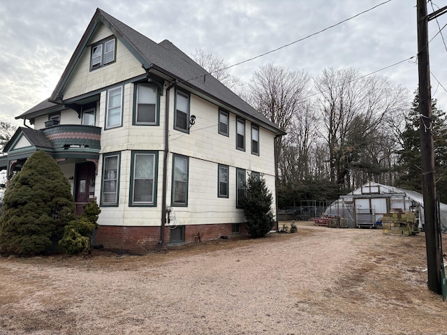 view of home's exterior with an outdoor structure