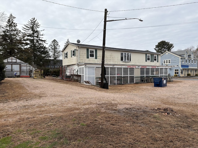 back of property featuring an outbuilding