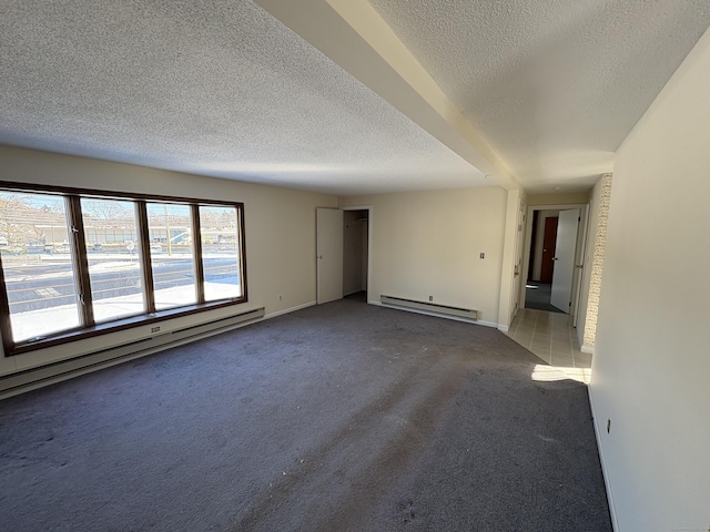 spare room with carpet floors, a baseboard radiator, and a textured ceiling