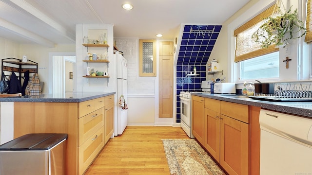 kitchen featuring light wood-type flooring, sink, and white appliances