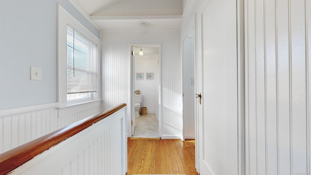 hall featuring a healthy amount of sunlight, light wood-type flooring, and radiator heating unit