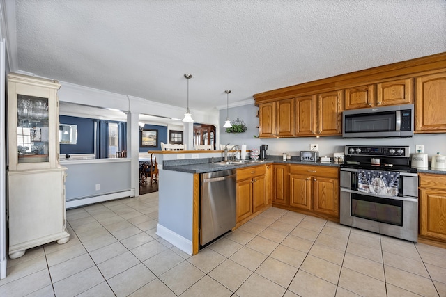 kitchen featuring a baseboard radiator, hanging light fixtures, ornamental molding, kitchen peninsula, and stainless steel appliances