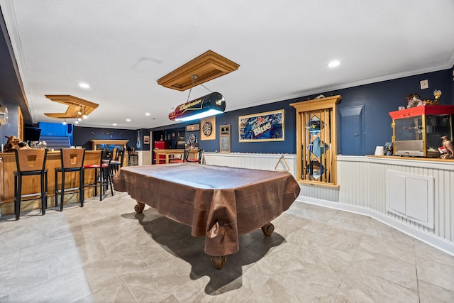 recreation room featuring billiards, ornamental molding, and bar area