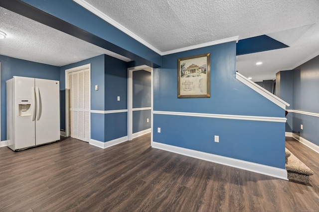 basement featuring crown molding, white refrigerator with ice dispenser, dark hardwood / wood-style floors, and a textured ceiling