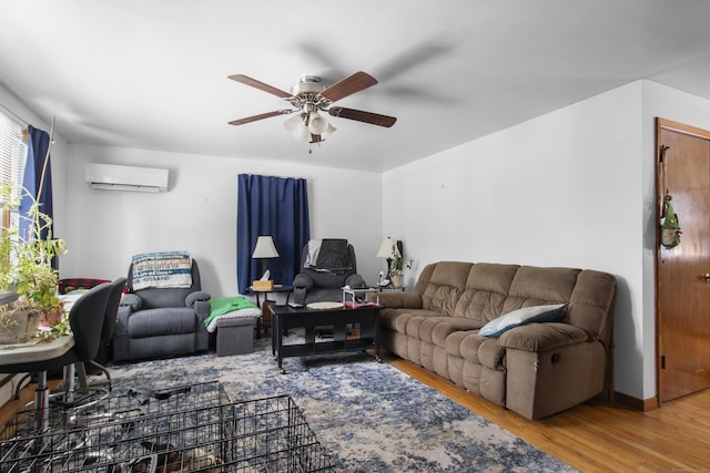 living room featuring hardwood / wood-style floors, an AC wall unit, and ceiling fan