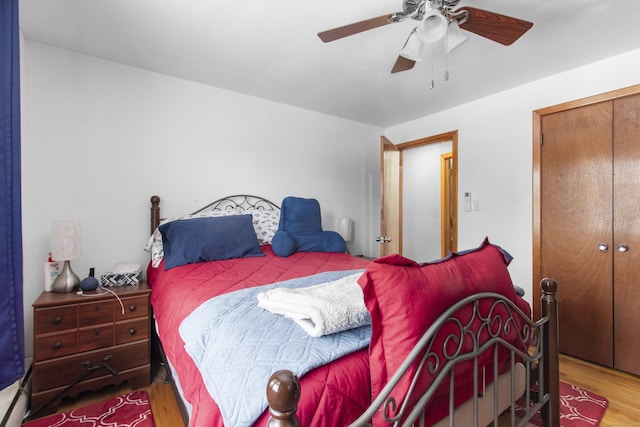 bedroom with ceiling fan, hardwood / wood-style floors, and a closet