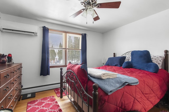 bedroom with ceiling fan, light hardwood / wood-style flooring, a wall mounted AC, and baseboard heating