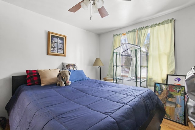 bedroom featuring hardwood / wood-style flooring and ceiling fan