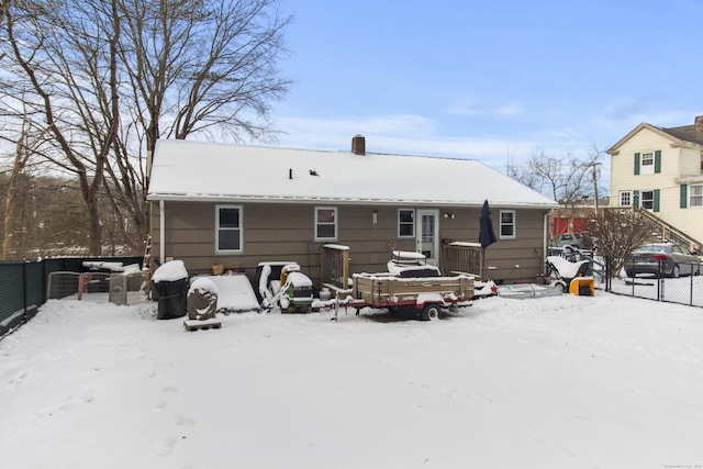 view of snow covered back of property