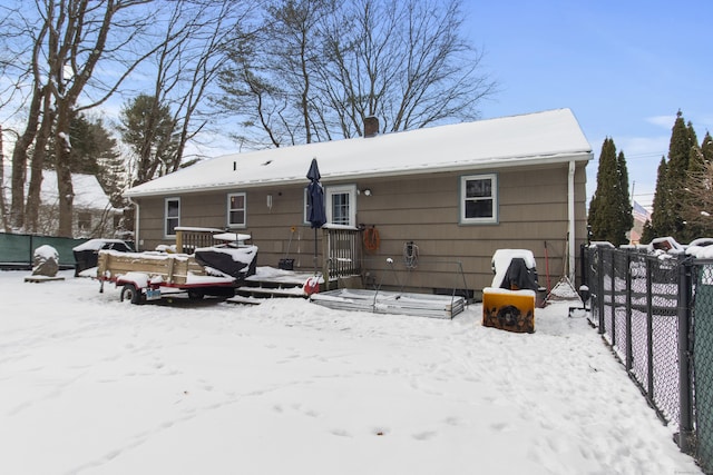 view of snow covered rear of property