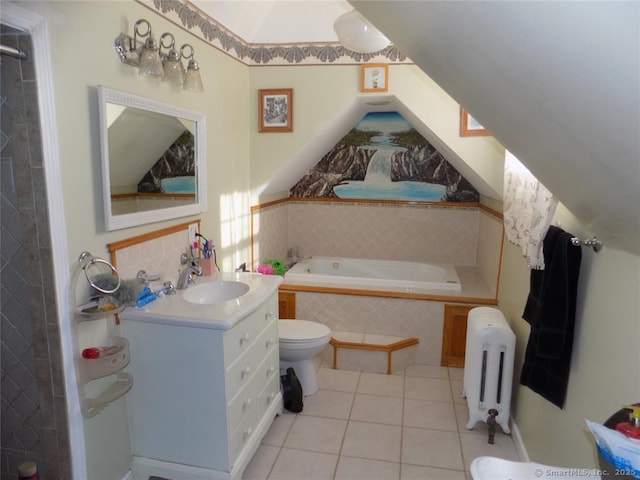 bathroom featuring toilet, vanity, tile patterned floors, tiled tub, and radiator