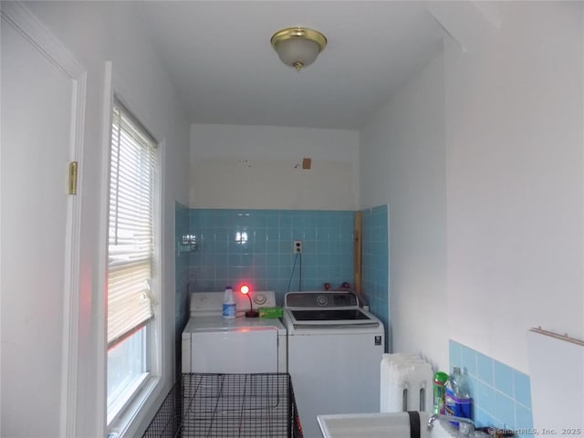 clothes washing area with independent washer and dryer