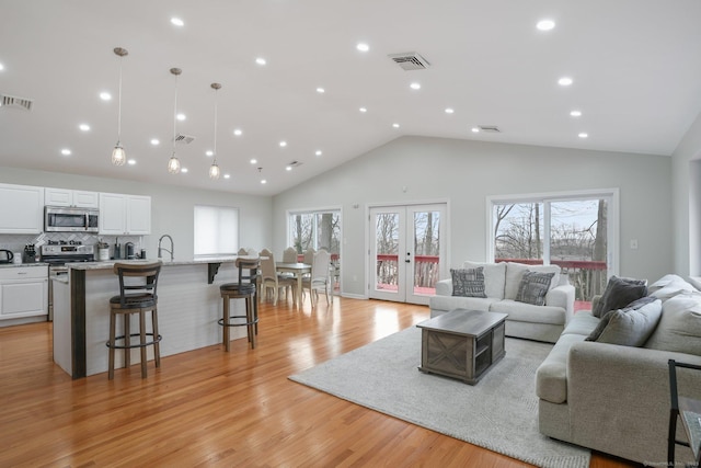12 Willowledge Cir, Waterbury, CT 06704 - living room featuring french doors, high vaulted ceiling, and light hardwood / wood-style floors