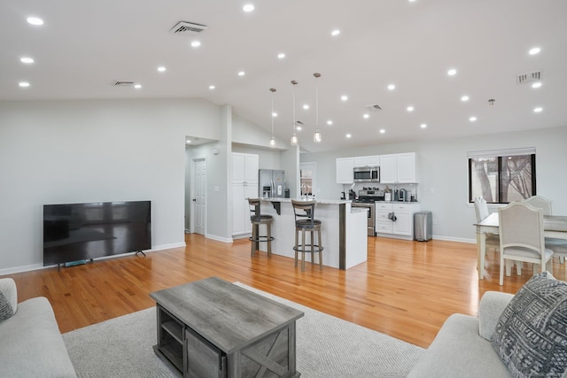 12 Willowledge Cir, Waterbury, CT 06704 - living room featuring vaulted ceiling and light wood-type flooring