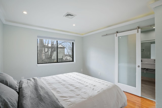 12 Willowledge Cir, Waterbury, CT 06704 - bedroom with hardwood / wood-style flooring, crown molding, a barn door, and sink