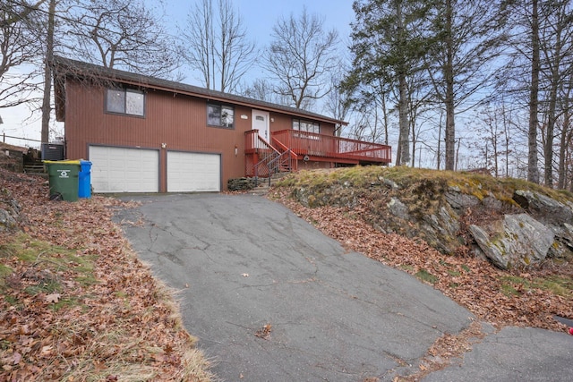 12 Willowledge Cir, Waterbury, CT 06704 - view of front of house with central AC unit, a garage, and a deck