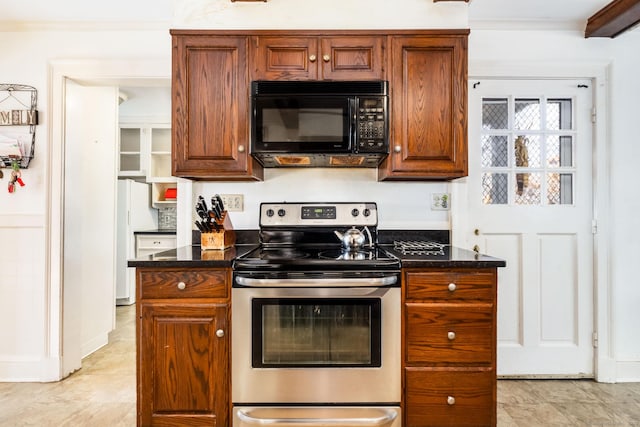 kitchen with brown cabinets, freestanding refrigerator, crown molding, stainless steel range with electric stovetop, and black microwave