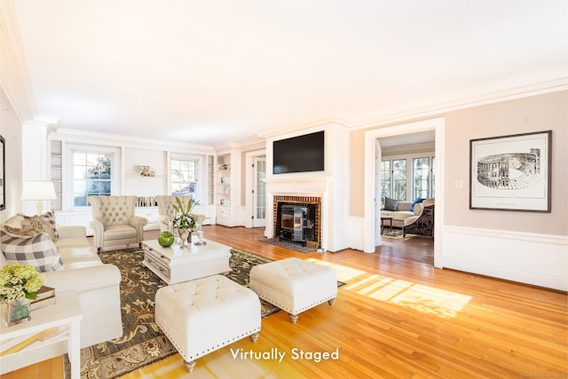 living area featuring ornamental molding and light wood-style floors