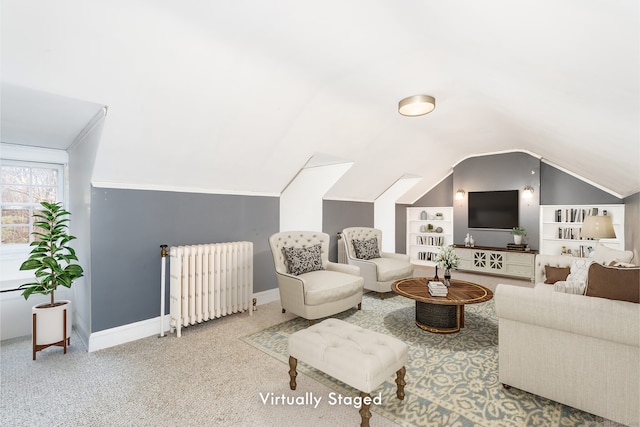 living area with carpet floors, lofted ceiling, radiator, and baseboards