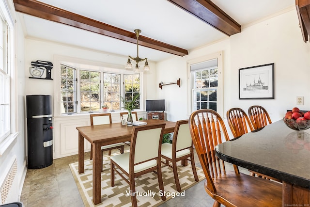 dining room featuring crown molding, beamed ceiling, and an inviting chandelier