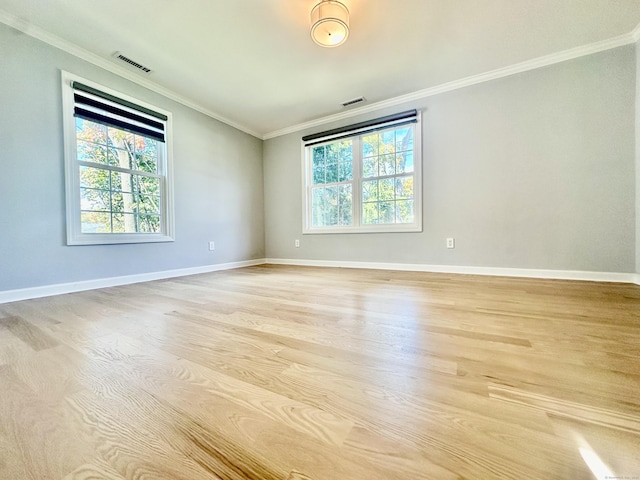 unfurnished room featuring light hardwood / wood-style flooring and crown molding