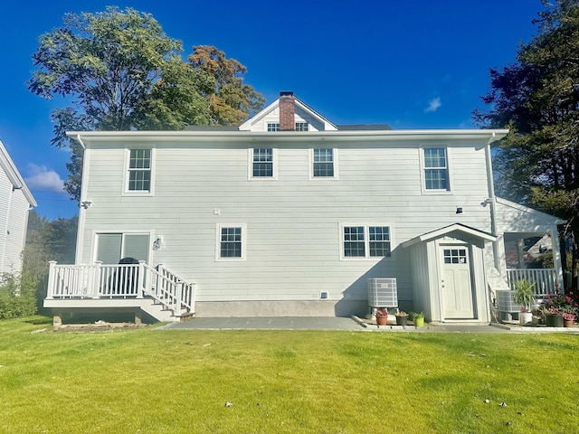 back of house featuring a yard