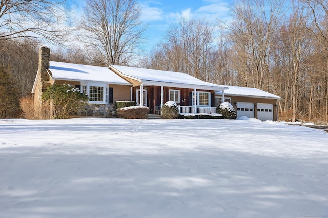 ranch-style home featuring a garage and covered porch