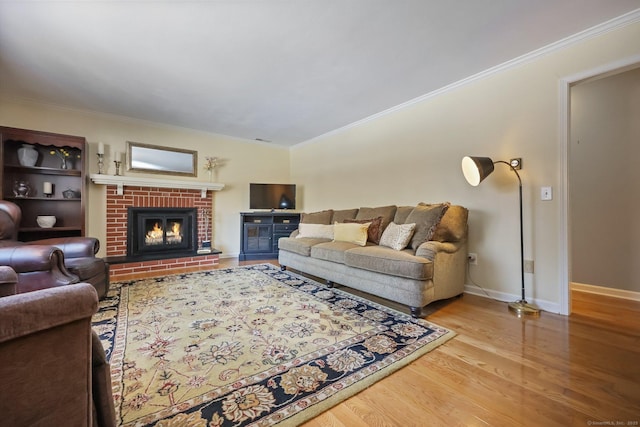 living room featuring crown molding, a brick fireplace, and hardwood / wood-style floors