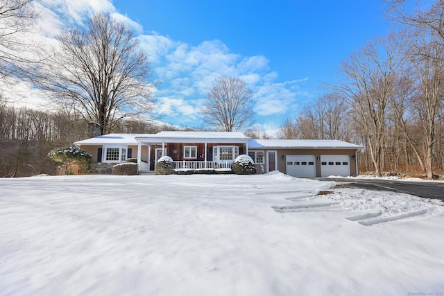 single story home featuring a garage and covered porch