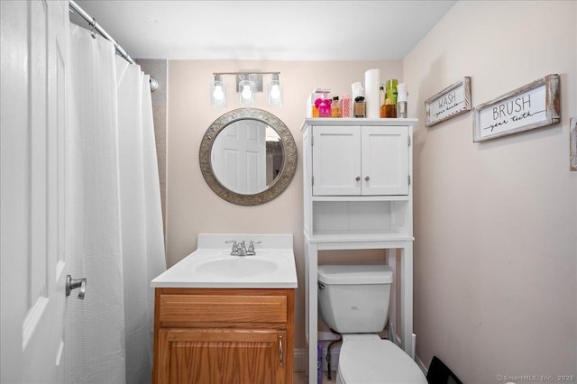 bathroom featuring toilet and vanity