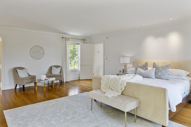 bedroom with crown molding and light hardwood / wood-style flooring