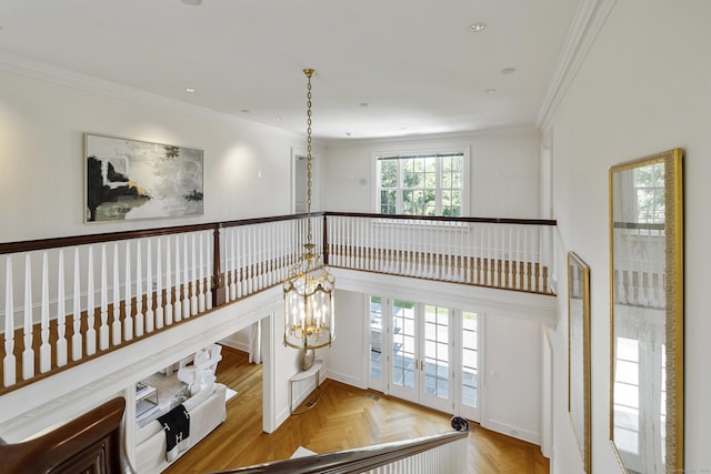 interior space with parquet flooring, crown molding, and a chandelier