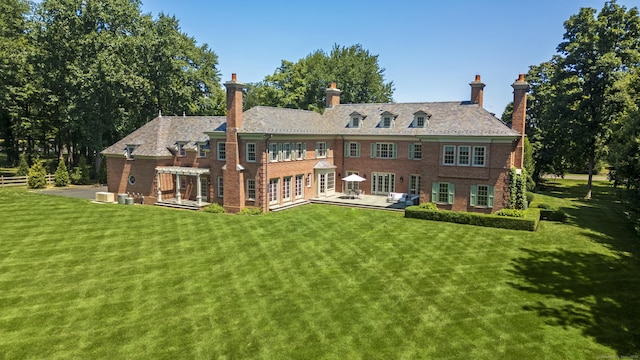 rear view of property featuring central AC, a yard, and a pergola